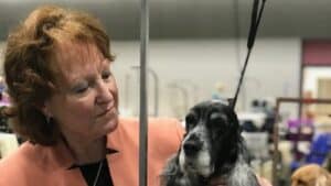 A photo of Bonnie Threlfall , a breeder of Edgewood English Cocker Spaniels, posing with her dog.