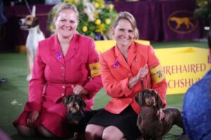 Tara Hartman, her daugther Paige, and 2 Dachshund dogs at a dog show